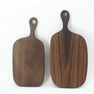 Solid black walnut bread boards with handles and natural wood grain on white background