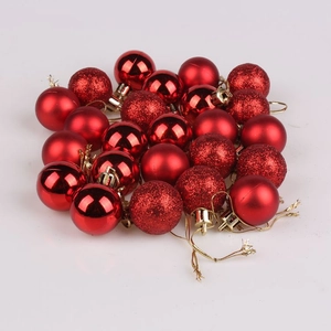 Detail of red Christmas baubles with shiny, matte, and glitter finishes for tree decoration
