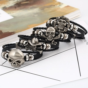 Punk style braided black leather bracelet set featuring silver skull metal charms