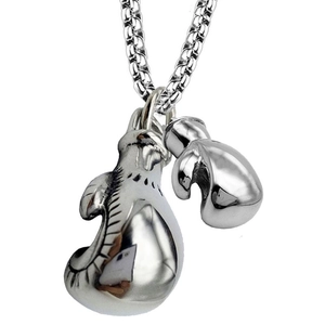 Macro shot of silver boxing glove pendants on a polished stainless steel necklace