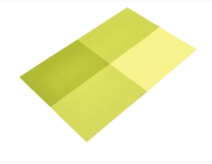 Detail of green woven PVC placemat featuring a classic cross-grid texture and non-slip surface