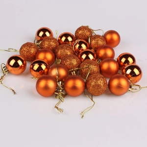 Close-up of bronze Christmas balls with shiny, matte, and glitter finishes on white background