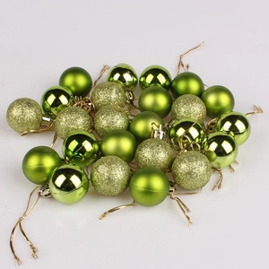 Detailed view of grass green Christmas tree ornaments with matte, glossy, and glitter finish