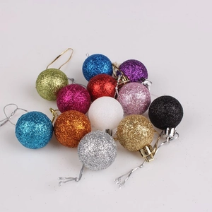 Close-up of assorted glitter Christmas ornaments in red gold and silver colors