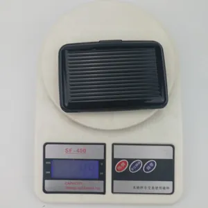 Aluminum RFID blocking card wallet weighing 49g on a digital scale for light travel