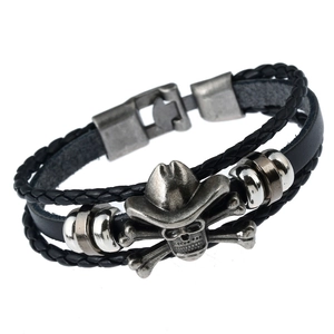 Braided leather bracelet with silver cowboy hat skull charm on professional white background