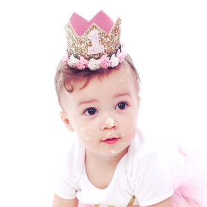 Detail of baby girl 1st birthday crown with gold glitter, pink felt and floral base