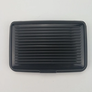 Detail view of black aluminum card holder with anti-slip horizontal wave texture