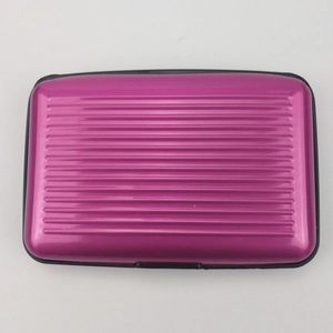 Top view of magenta aluminum card holder with ribbed texture and black protective edges