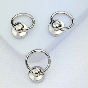 Detail of three silver alloy metal screw rings for DIY phone case charm attachment