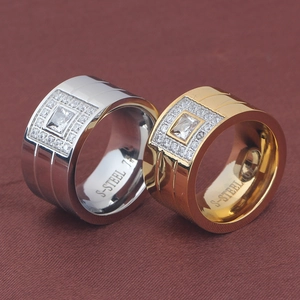 Macro shot of 18K gold and silver stainless steel rings with square zircon inlay