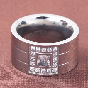 Macro shot of silver stainless steel ring featuring square zircon inlay and S.STEEL engraving