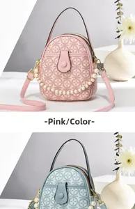 Close-up of pink and blue leather bags with pearl chains and logo embossed texture