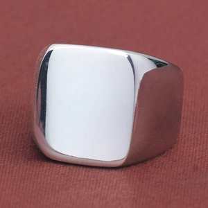 Close-up of polished silver square signet ring with a smooth mirror finish for men