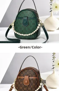 Detail view of mini crossbody bag with vintage clover print and decorative pearl chain