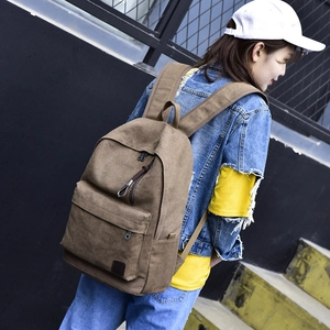 Classic dark brown canvas backpack featuring large capacity and retro travel styling
