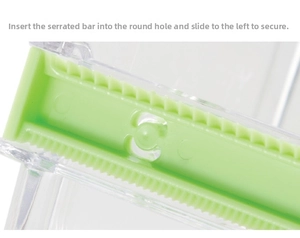 Detail of the serrated fixer and sliding lock mechanism on the clear tape dispenser