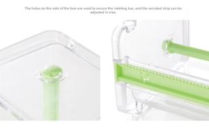 Macro view of clear tape dispenser with adjustable green cutter blades and spindle mounts