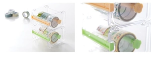 Macro detail of stackable clear plastic washi tape dispenser box with jagged cutters