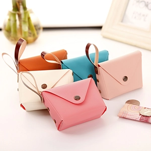 Detail of candy-colored faux leather mini coin purses with snap buttons and wrist straps