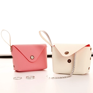 Mini macaron style jewelry storage pouch in pink and off-white faux leather with metal snap