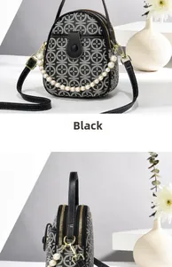 Detail of black and white jacquard mini bag with pearl handle and golden hardware