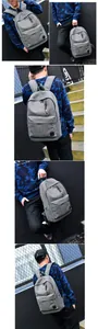 Detail of grey canvas backpack with brown leather zipper pulls and reinforced base