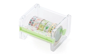 Close-up of transparent tape dispenser with green serrated blade and colorful washi tapes