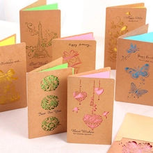 Close-up of stacked kraft 3D birthday cards with gold foil lettering and colorful pages
