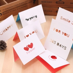 Assorted creative vintage greeting cards with gold stamping on rustic wooden surface