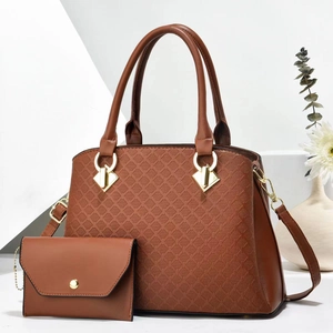 Detail view of brown quilted leather tote with matching clutch and golden ring hardware