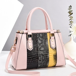 Elegant pink handbag with crocodile texture panels and adjustable crossbody strap