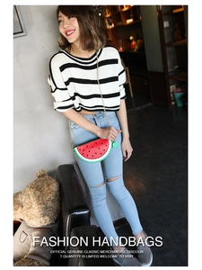 Detailed close-up of a watermelon shaped crossbody bag with a gold metal chain strap