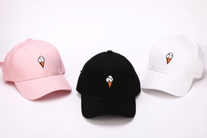 Detailed close-up showing embroidered ice cream patterns on colorful cotton baseball caps