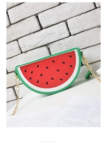 Detail of watermelon crossbody bag with green rind and red pulp texture and gold chain