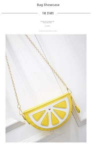 Detailed view of yellow lemon-shaped cross-body bag with golden metal chain strap