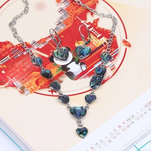 Detail of vintage heart-shaped shell jewelry set with necklace and drop earrings