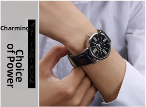 Close-up of classic quartz watch with black roman dial and leather strap on wrist