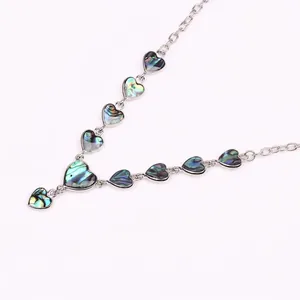 Vintage heart necklace with iridescent shell inlays in polished silver link chain