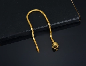 Close-up of golden 316L stainless steel snake chain with durable lobster clasp detail
