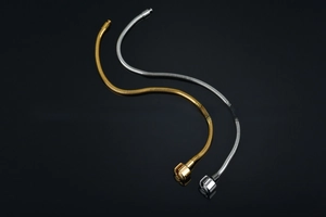 Detailed macro view of 316L stainless steel snake chains in gold and silver finishes