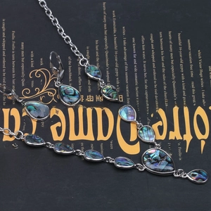 Detailed set of vintage shell necklace and earrings with colorful abalone inlay patterns
