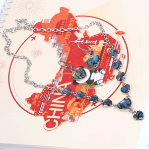Vintage jewelry set with heart-shaped abalone shell pendants and silver necklace chain