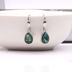 Detail of teardrop shell earrings featuring vibrant rainbow abalone shell in silver frame