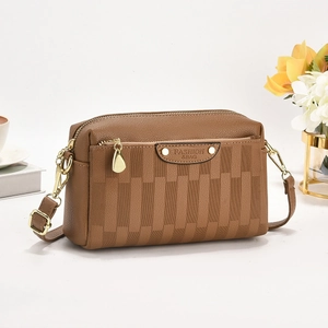 Brown lychee leather crossbody bag with geometric weave and gold hardware
