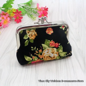 Close-up of vintage floral canvas coin purse with silver metal kiss-lock clasp