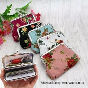 Floral cotton kiss-clasp purses with rose patterns showing compact storage capacity