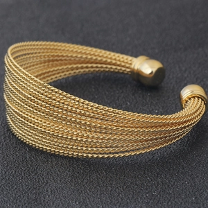 Detail view of 20mm gold twisted stainless steel wire open bangle with ball ends