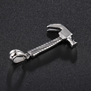 Polished stainless steel hammer pendant necklace for men with textured handle on dark background