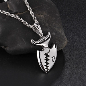 Cool stainless steel crocodile tooth pendant necklace with a twisted chain on black stone